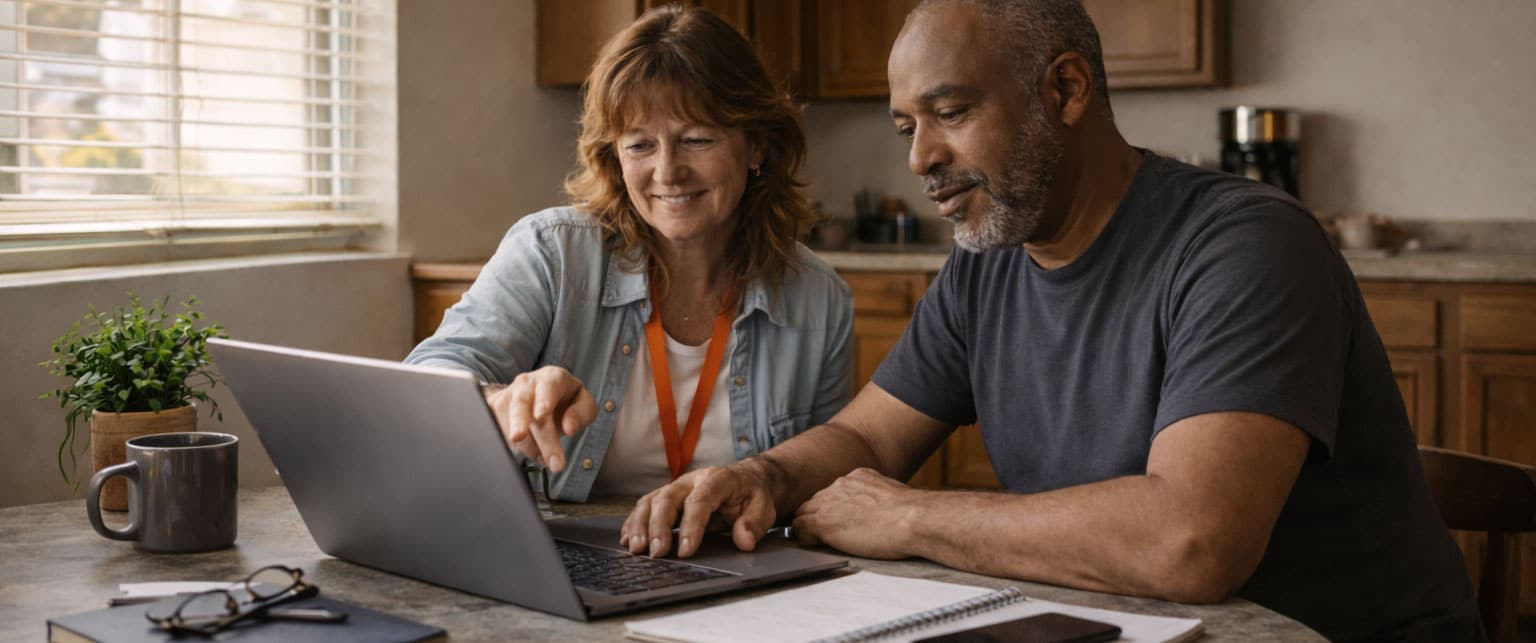 Reveille Foundation staff member helping a community member search for local support services on a laptop